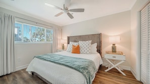 A spacious king bedroom with a TV, walk-in closet, and cozy, restful ambiance.