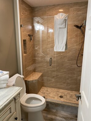 Downstairs bath with tiled shower glass doors