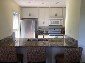 New kitchen with eat at counter top.  Fully stocked larder.  Everything you need