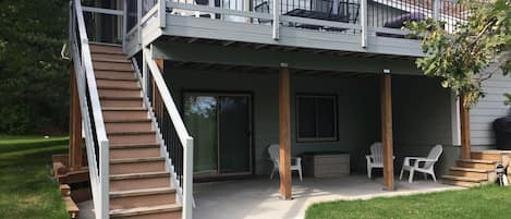 Deck and patio overlooks the vast yard and surrounding wooded acreage.