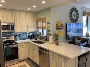 Remodeled kitchen as of 2020 and large smart TV.