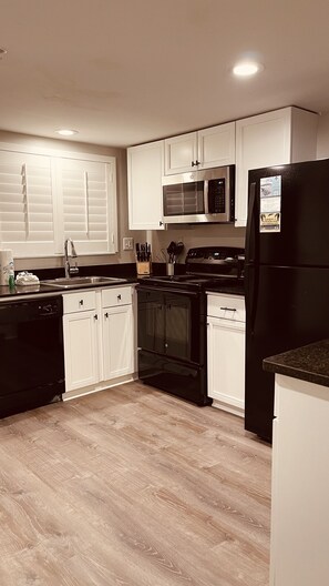 Updated December 2023 . White Kitchen Cabinets and new window shutters .