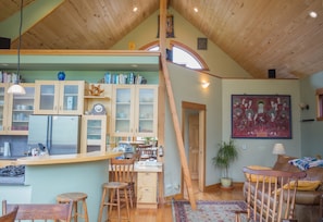 View of loft, loft access ladder and bar/kitchen area.