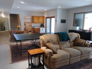 Dining/living room with ping pong table.