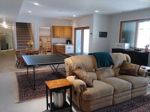 Dining/living room with ping pong table.