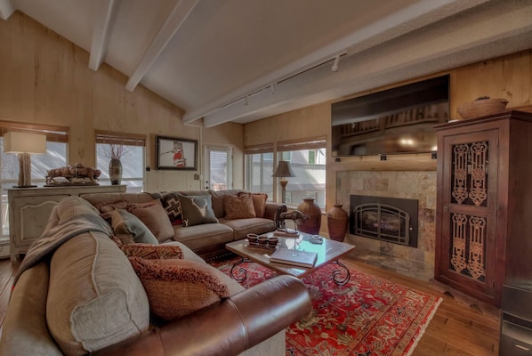 Cozy living room with gas fireplace & 75 inch flat screen tv