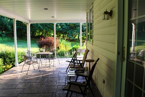 Large back porch for bird watching, reading or watching the horse and buggies.