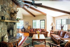 Upstairs great room with fireplace, lake views, game table and 52" smart tv.
