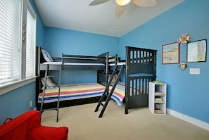 First floor bedroom with two sets of bunk beds and 1 trundle.