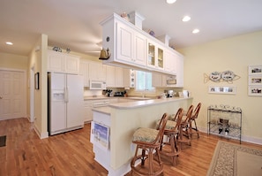 Fully equipped kitchen with bar top seating.