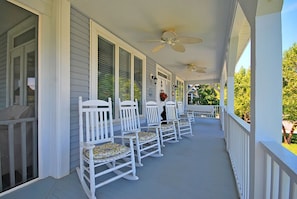 Covered porch with lots of seating.  What a great place to sit and relax after a day at the beach.