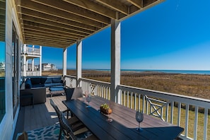 Front row beach - Main deck with comfortable sectional sofa and outdoor dining 