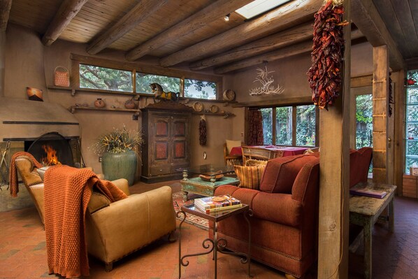 Great Room with high viga beam ceilings, brick floors, and antler chandelier.