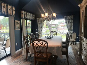 Dining Room with window overlooking manicured lawn and  lake. 
Slider to deck 