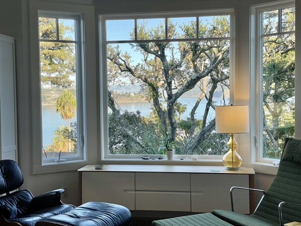 Living room with loungers and views of the Bay.  Condo freshly painted Jan 2024.