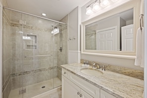Gorgeous renovated bathroom with glass shower.