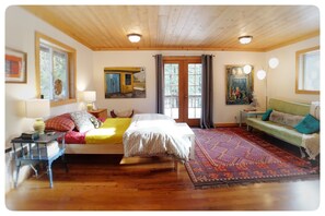 Bright, spacious master suite  features a balcony, sofa bed, attached bathroom