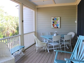 Step to the porch and enjoy appetizers around the table for six.