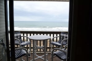 Oceanfront balcony with table and 4 bar height chairs