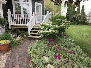 Steps to porch entrance with fountain on left