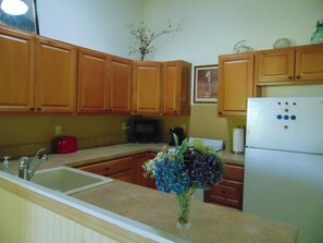 Kitchen includes range/oven, microwave, refer, dishwasher, toaster, coffee maker