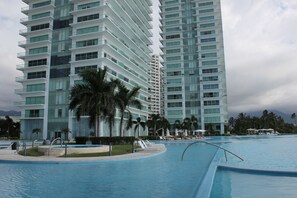 Pool with lounge chairs, umbrellas, and day beds provided.