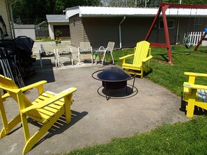 fire pit area and wood along with roasting sticks