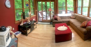 SUN ROOM WITH SMART TV HEADING OUT TO BACK DECK.