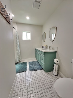 Bathroom 1 with double sink and shower.