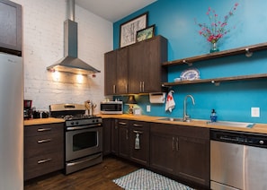 Full kitchen with gas stove and dishwasher.