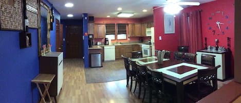 Open kitchen, dining and open kitchen with bar and large dining table.