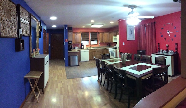 Open kitchen, dining and open kitchen with bar and large dining table.