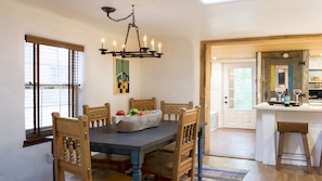 Dinning room with adobe inspired solid wood chairs to seat 5