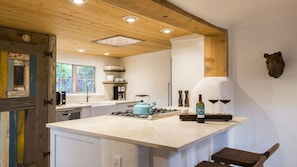 Beautifully remodeled and fully appointed kitchen with genuine travertine stone