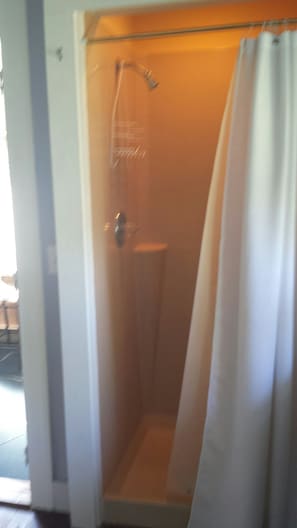 full shower on the side of kitchen area original plumbing route dictated this