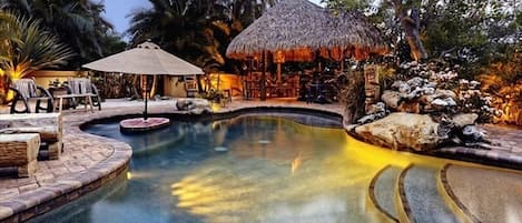 The lagoon pool in the evening.  Beach entry, baja ledge and swim cocktail table