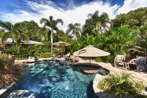 Private tropical lagoon with waterfall, beach entry, baja ledge and swim up bar