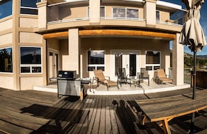 Expansive back deck facing west with a view of Skaha Lake