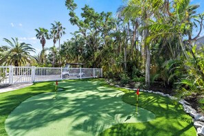 Putting green off the patio.  Multiple holes allow for different lengths, slopes, and breaks, improving overall putting skills.