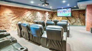 Indoor theater room w/ projector TV, sound system, & 15 luxury recliners