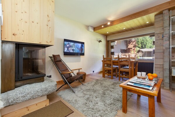 Homely living room with a log fire and HDTV