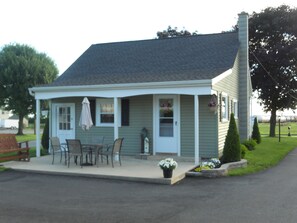 Back of Bungalow has patio with table and chairs