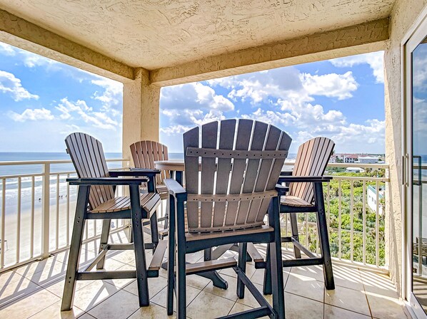 Private Oceanfront Balcony with seating for 4 and an ocean front view.