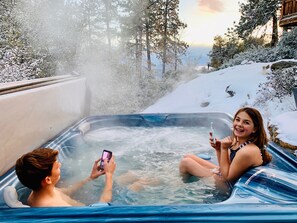 Hot tub located on among the trees on the one acre property.