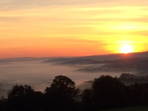 Early morning sun rise with mist in the valley