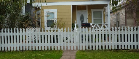 Front of the house with a newly built picket fence.