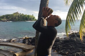 Ali enjoying his daily fresh coconut  juice after a swim w/turtles and dolphoms