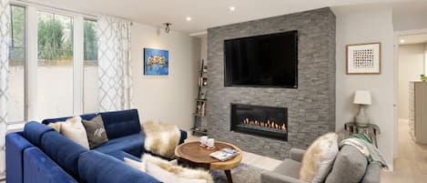 Stylish and updated living room with gas fireplace, sectional sofa & sonos