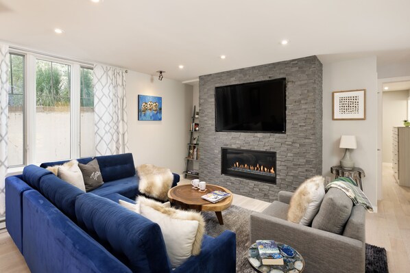 Stylish and updated living room with gas fireplace, sectional sofa & sonos