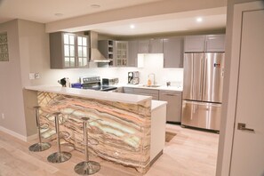 Back-lit onyx on the breakfast bar make for a one-of-a-kind setting inside.